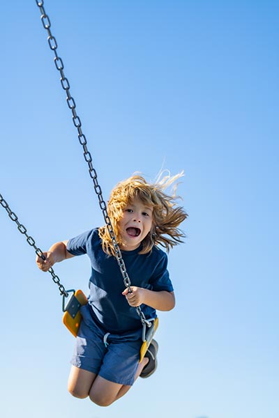 Child swinging on a playground in Calabasas